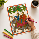A hand holds a pink marker over a colorful illustrated art print showing two decorated figures on elephants under a tree, set on a white desk with colored markers and a coffee cup nearby.