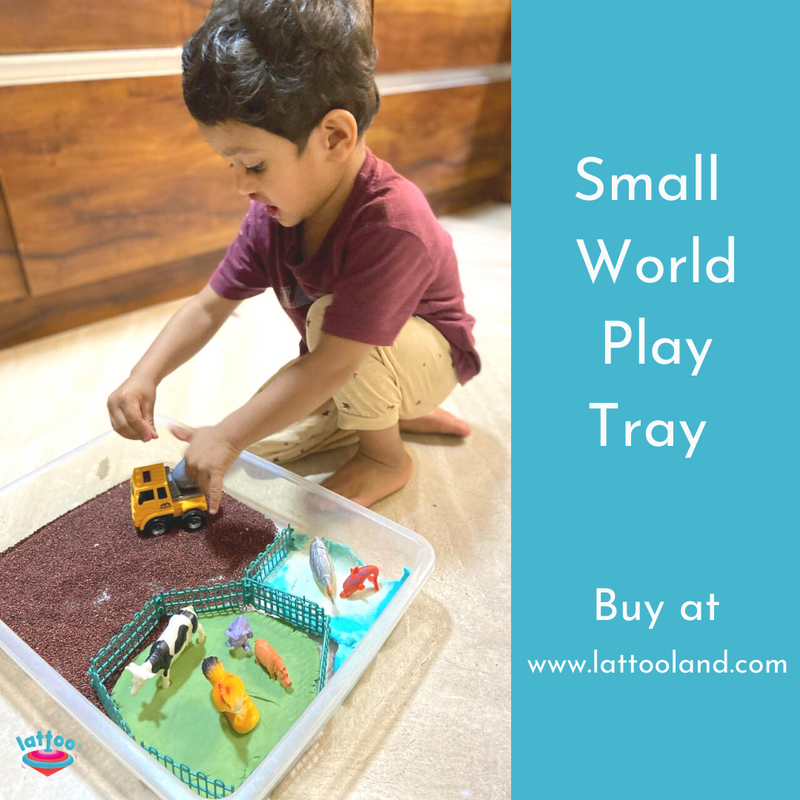 Small World Play set up in a Sensory bin and a small boy playing with it